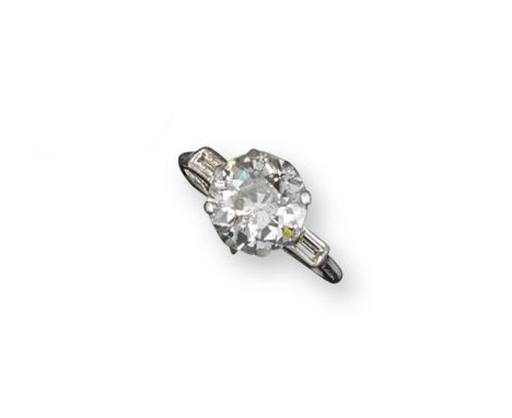 A diamond solitaire ring, the round brilliant-cut diamond weighs approximately 3.50cts and is set with two baguette-shaped sh