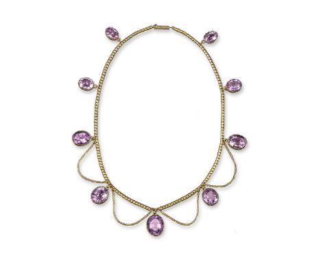 A Victorian amethyst pendant necklace,  the gold fine link necklace is mounted with nine graduated oval shaped amethysts in c