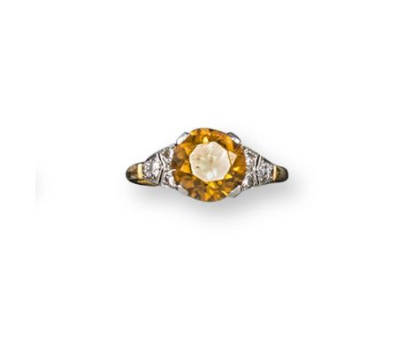 A gold and zircon and diamond set ring, the circular cut zircon is millegrain set with four small circular cut diamonds to ea