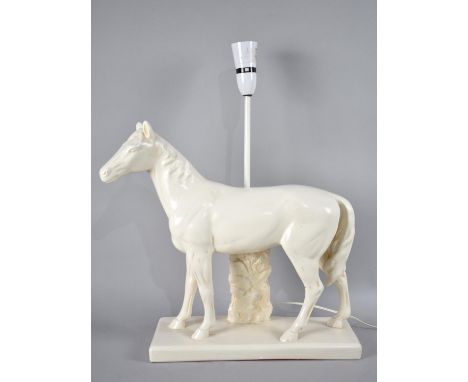 A Cast Composition Table Lamp in the Form of a Standing Horse, Complete with Shade, 64cms High 