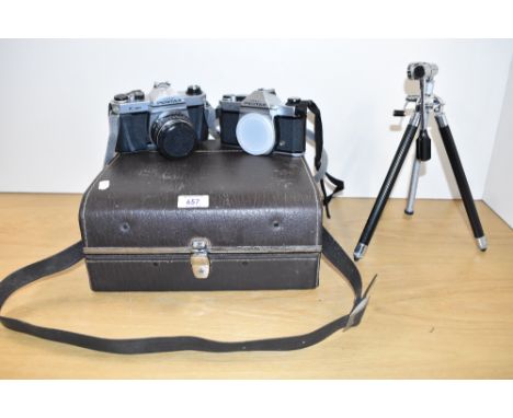 Two Pentax K1000 camera bodies one with a SMC Pentax 1:2 55mm lens with hard camera case connector and flash and sod with a v