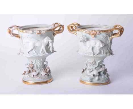 A pair of ornate Continental porcelain vases richly embellished with hunting subject matter and gilt handles, unglazed, heigh