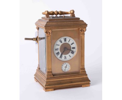 A good French brass cased carriage clock with repeat movement striking on a bell with two dials with roman and arabic numeral