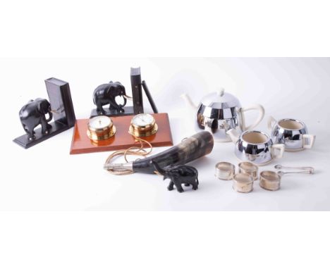 A pair of black ebony elephant bookends, a chrome and ceramic Deco teaset, a horn, a clock barometer replica set, silver plat