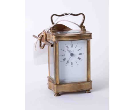 A 20th century brass cases carriage clock with platform movement and key, the dial marked Angelus, height 16cm (handle up).