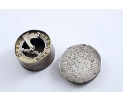 A SMALL LATE 17TH CENTURY POCKET COMPASS &amp; SUNDIAL COMBINED circular with a pull-off cover, engraved with a coat of arms*
