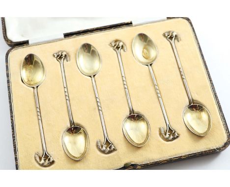 AN EARLY 20TH CENTURY CASED SET OF SIX PARCELGILT TEA SPOONS on a hunting theme, each with a cast fox terminal, by Walker & H