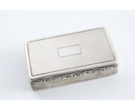 A WILLIAM IV RECTANGULAR ENGINE-TURNED SNUFF BOX with reeded sides, a raised floral thumbpiece & a vacant cartouche on the co