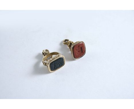 A REGENCY GOLD SEAL  with cornelian engraved with a coat of arms (Shand), 2.5 cms and another, the black intaglio engraved wi