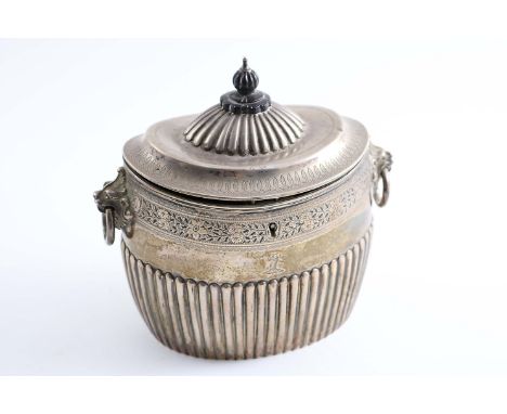 A VICTORIAN PART-FLUTED OVAL TEA CADDY with twin, lion mask & drop-ring handles, engraved borders and a lock, crested, gilt i