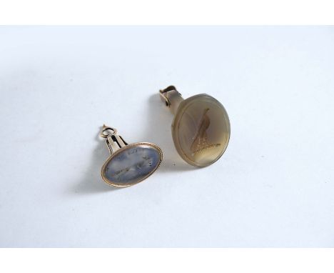 A REGENCY FACETED AGATE SEAL oval intaglio, engraved with crest of a hawk, 4 cms and a gold mounted seal with stone engraved 