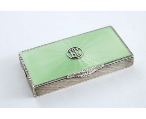 A CONTINENTAL ART DECO COMPACT with a pale green enamelled cover and a sprung clasp, the gilt interior with twin compartments