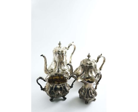 A VICTORIAN EMBOSSED FOUR-PIECE TEA & COFFEE SERVICE with scroll handles, scroll feet and matted leaf decoration around the b