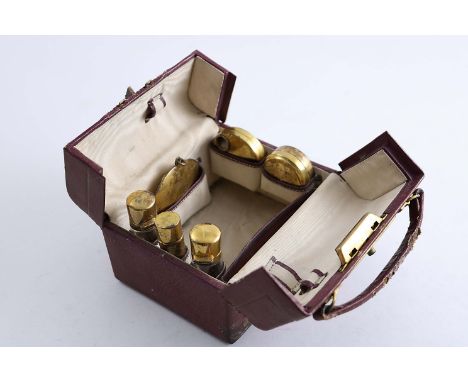 AN EARLY 20TH CENTURY MINIATURE TOILET CASE with six silvergilt fittings (a compact, two boxes, two mounted bottles and a lip