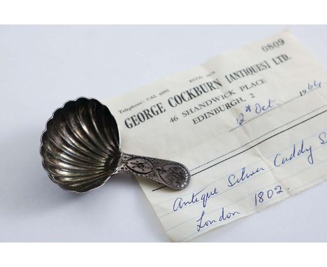A GEORGE III CADDY SPOON with a fluted bowl and a bright-cut stem, initialled, by D. Urquhart & N. Hart, London 1802;  2.8" (