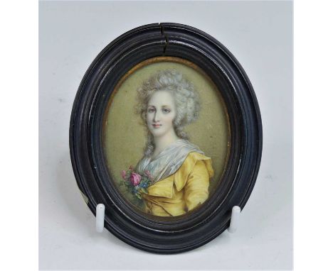 A half-length portrait miniature of a lady, late 18th/early 19th century, shown standing in a yellow jacket, watercolour on i