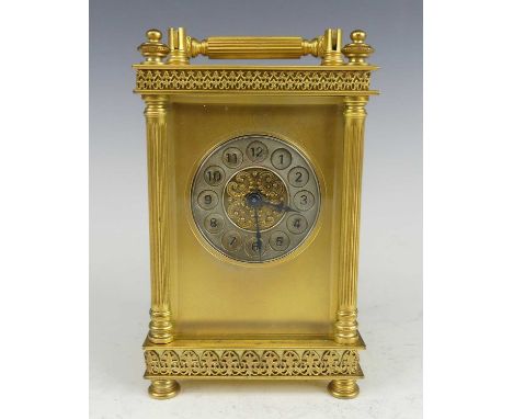 A circa 1900 lacquered brass carriage clock, the case with applied Anthemian type decoration, having three-quarter turned flu
