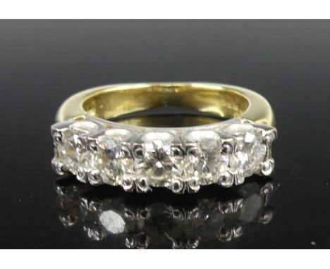 An 18ct yellow and white gold diamond half eternity ring, comprising five round brilliant cut diamonds in claw settings, diam