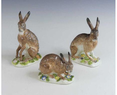 A set of three Meissen porcelain models of hares, circa 1750, modelled by J.J. Kaendler, naturistically coloured and mounted 