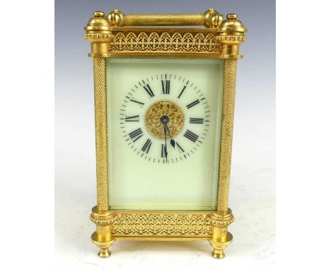 A circa 1900 French gilt brass cased carriage clock, the case with applied decoration and engine turned pilasters flanking an