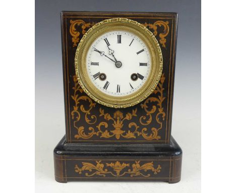 A late 19th century ebonised and marquetry inlaid carriage clock, having an unsigned white enamel dial with twin winding hole