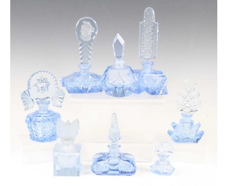 An Art Deco blue tinted glass scent bottle, the cut glass body of boat shape, the stopper etched with a profile portrait of a
