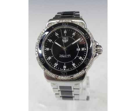 A Tag Heuer lady's stainless steel Formula One bracelet watch, having factory diamond set signed black dial and ceramic bezel