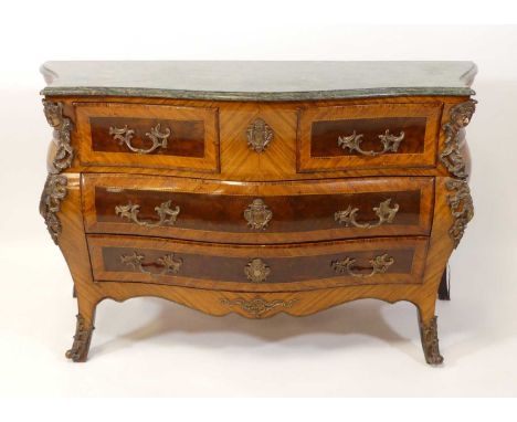 A walnut and kingwood marble topped bombe commode in the Louis XV style, having gilt metal mounts, two short and two long dra