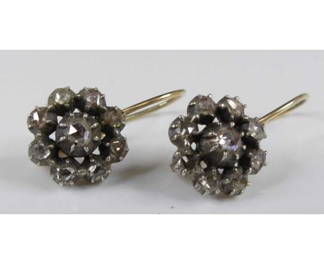 A pair of yellow and white metal diamond flower cluster drop earrings, each with nine rose cut diamonds in cut-down grain set