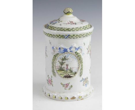 A Veuve Perrin tin-glazed earthenware jar and cover, circa 1770, of cylindrical form, decorated with a figure within a landsc