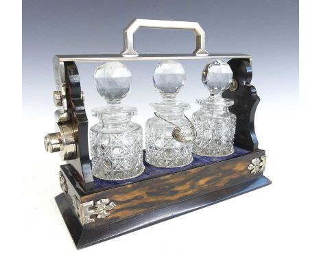 A Victorian coromandel and silver plated miniature three-bottle tantalus, with Betjemanns patent action, the bottles each wit