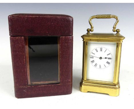 A circa 1900 French lacquered brass minuet carriage clock, having an unsigned white enamel Roman dial, visible platform escap