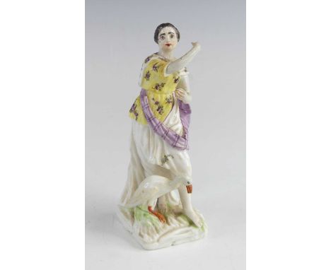 A Mennecy porcelain figure of a girl, circa 1750, shown standing with arms raised beside a goose, incised DV to the underside