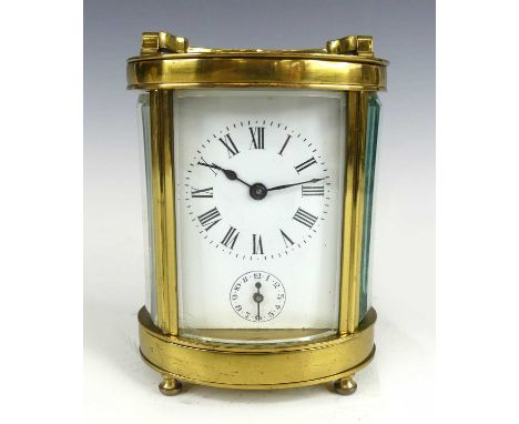A circa 1900 French lacquered brass barrel shaped carriage clock with alarm, having unsigned white enamel Roman dial with sub