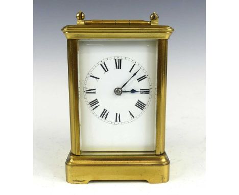 A circa 1900 French lacquered brass carriage clock, having an unsigned white enamel Roman dial, visible platform escapement, 