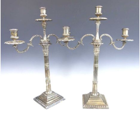 A pair of George II silver candlesticks with Victorian silver twin-branch three light candelabra over, of Corinthian column f