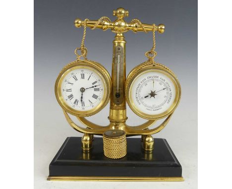 A circa 1900 nautical desk brass clock barometer, as a central anchor with applied thermometer supporting twin barrels, housi