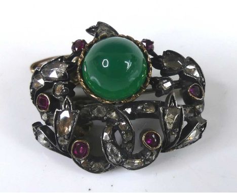 A white and yellow metal chrysoprase, ruby and diamond brooch, featuring a 9.7 x 7.15mm round chrysoprase cabochon within a f