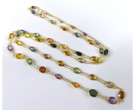 A contemporary 14ct gold multi-sapphire set necklace, arranged as 43 oval cut bezel set sapphires, each measuring approx 5.7 