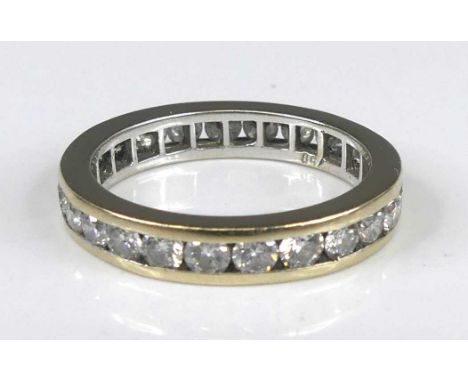 A white metal diamond eternity ring, having 25 round brilliant cut diamonds in channel settings, diamond diameters each appro