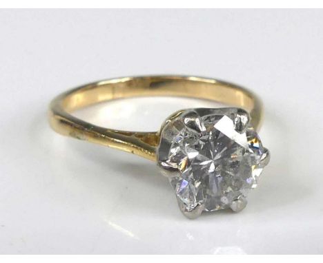 A yellow and white metal diamond solitaire ring, featuring a round brilliant cut diamond in a six-claw setting, diamond dimen