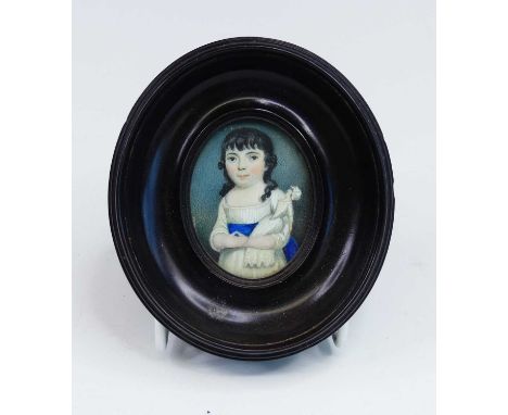 A half-length portrait miniature of a young girl, 19th century, shown standing holding a doll, watercolour on ivory, 5cm x 3.