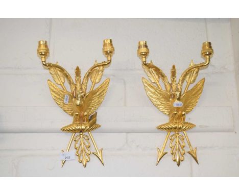 A pair of modern gilt metal wall sconces with eagle and arrow decoration