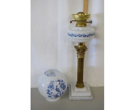 An oil lamp with brass corinthian column base