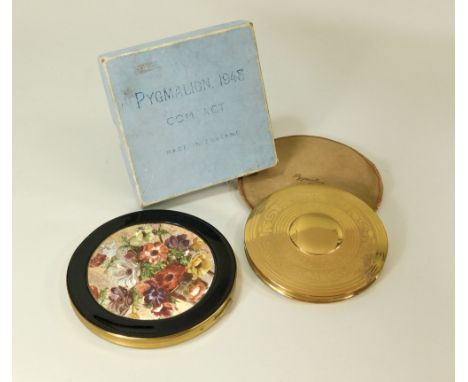 POWDER COMPACTS.An extra large Pygmalion, 1948 gold tone powder compact, in original box & one other, extra large, Anemone co
