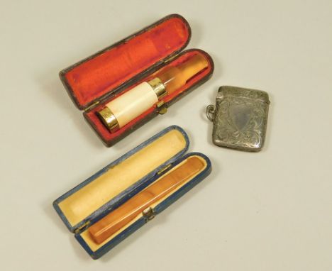 VESTA CASE ETC. A Victorian silver vesta case, an 18ct. gold plated cigar holder with amber mouthpiece &amp; an amber cigaret