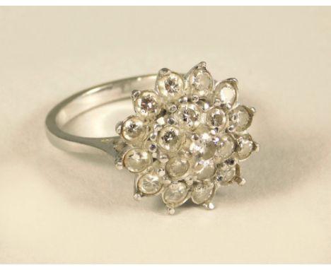 COCKTAIL RING. An 18ct. white gold diamond cluster cocktail ring, set throughout with brilliant cut diamonds in a coronet set