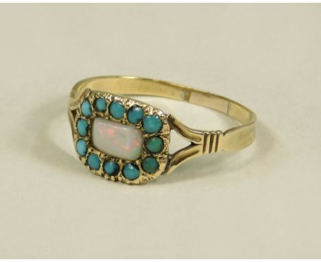 OPAL RING.A 19th century yellow metal ring (resized), the front set an opal within a turquoise border. (O/P).