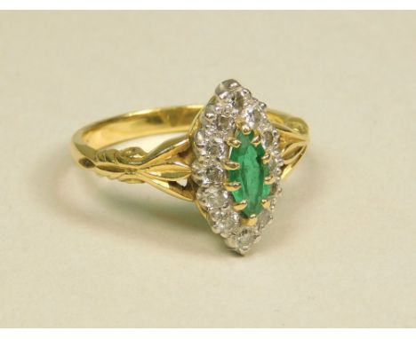 EMERALD RING. An 18ct. gold emerald &amp; diamond marquise ring. (N).