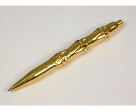 GOLD BALLPOINT. A 14ct. gold cased, faux bamboo ballpoint pen. Length 10.5cm.